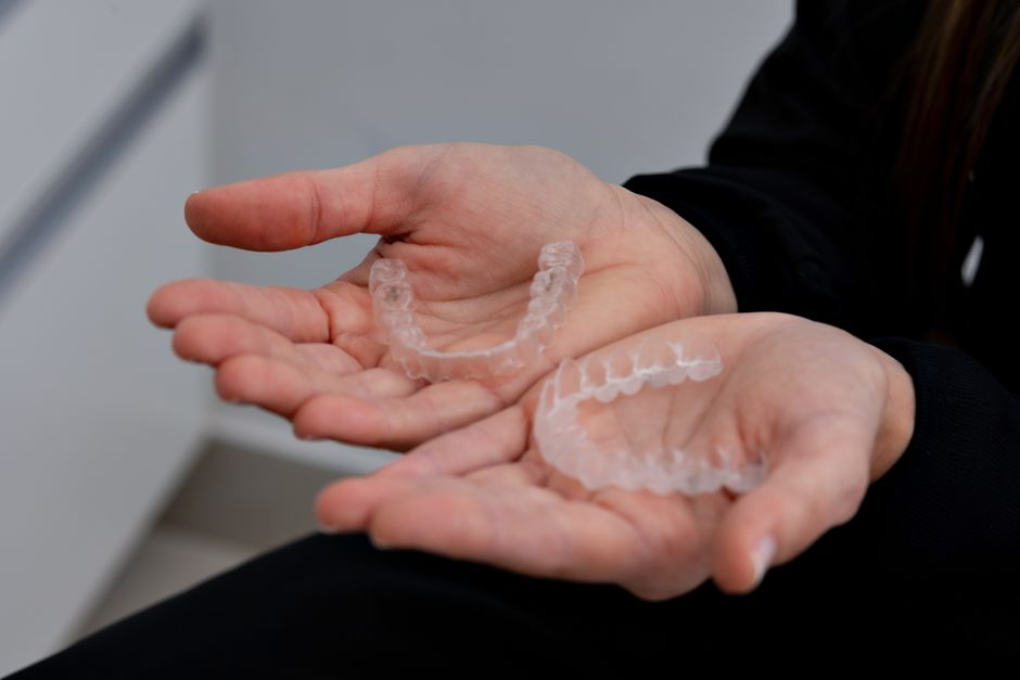 Clear aligners held in hand